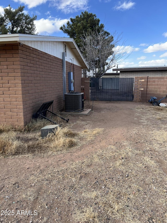 view of yard with fence and central AC unit