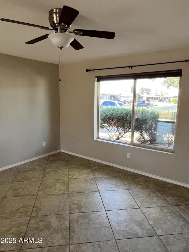 empty room featuring tile patterned flooring and baseboards