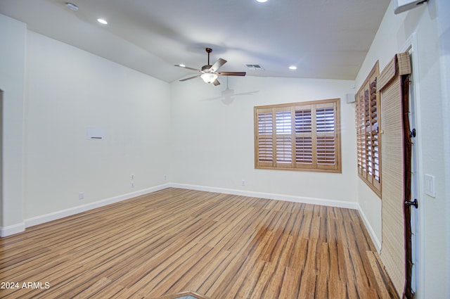 spare room featuring light wood-type flooring, ceiling fan, and lofted ceiling