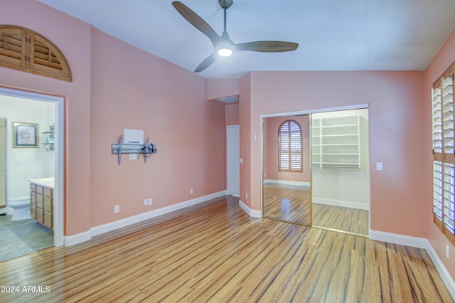 unfurnished living room with ceiling fan, light hardwood / wood-style flooring, and lofted ceiling