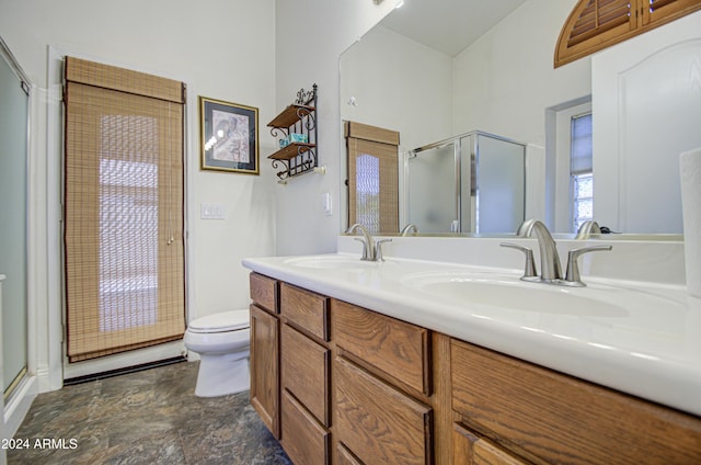 bathroom featuring toilet, vanity, and an enclosed shower