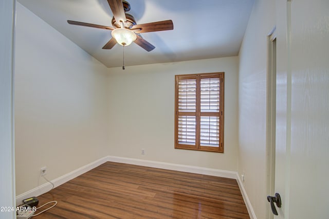 unfurnished room with ceiling fan and dark hardwood / wood-style flooring