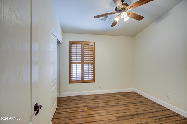 unfurnished room with ceiling fan and dark wood-type flooring