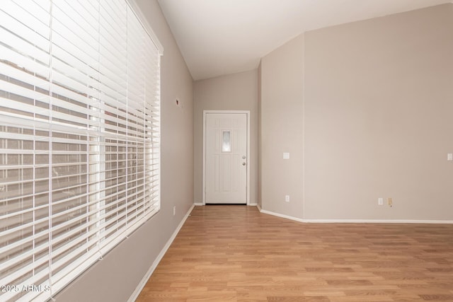 entryway featuring vaulted ceiling and light hardwood / wood-style floors