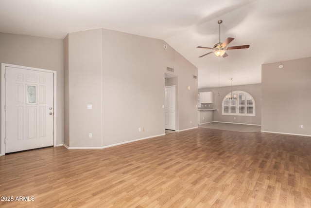 unfurnished living room featuring vaulted ceiling, ceiling fan, and light hardwood / wood-style floors