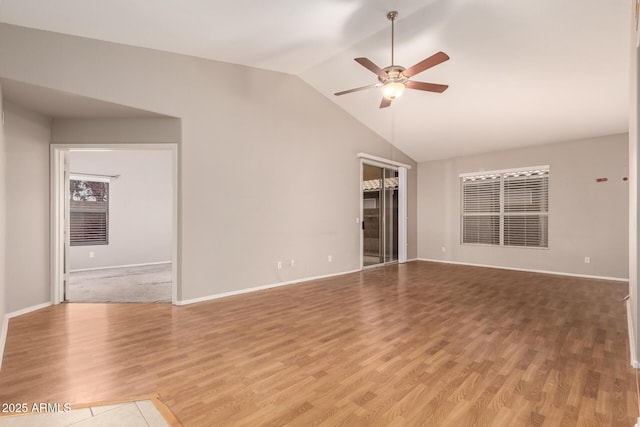 spare room featuring hardwood / wood-style floors, high vaulted ceiling, and ceiling fan