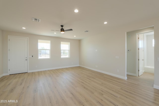 empty room with light wood-style floors, baseboards, visible vents, and recessed lighting