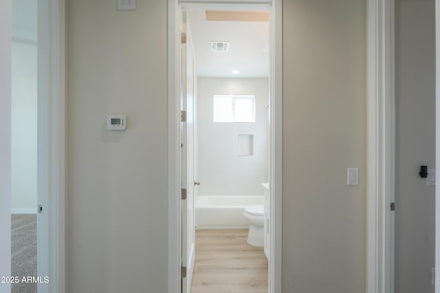 bathroom featuring toilet, visible vents, and wood finished floors