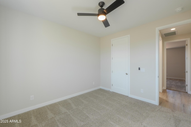 unfurnished bedroom with baseboards, visible vents, ceiling fan, and carpet flooring