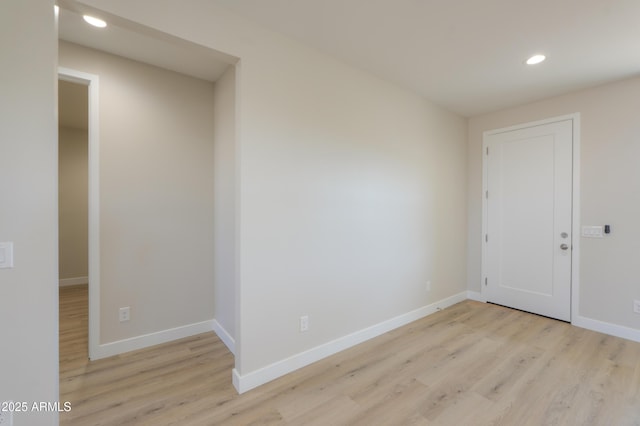 spare room with light wood-type flooring, baseboards, and recessed lighting