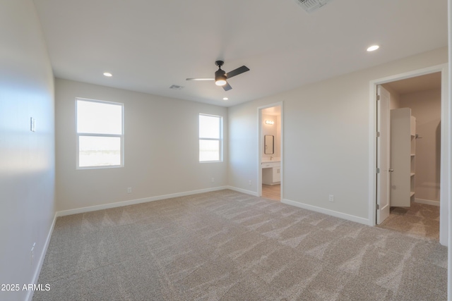 unfurnished bedroom featuring recessed lighting, baseboards, connected bathroom, and light colored carpet