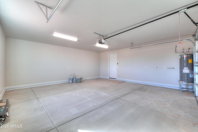 garage featuring baseboards, electric water heater, and a garage door opener