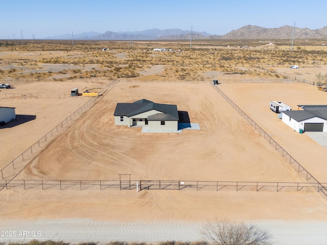 drone / aerial view featuring a rural view, a mountain view, and view of desert