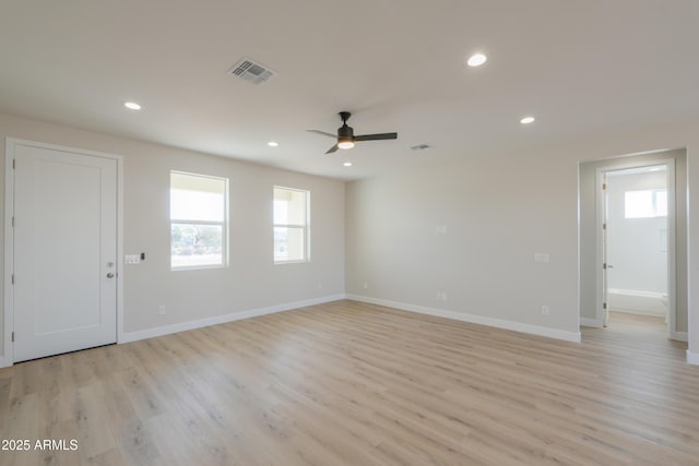 spare room with light wood-type flooring, recessed lighting, visible vents, and baseboards