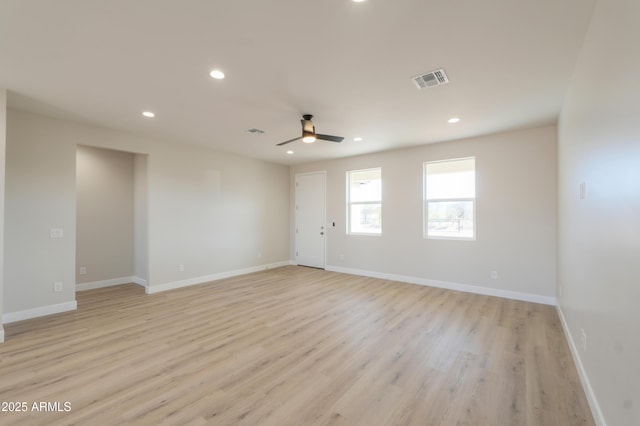 spare room with recessed lighting, visible vents, and baseboards