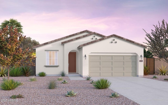 12550 W Luxton Ln, Avondale, AZ 85323 - mediterranean / spanish-style home with driveway, stucco siding, and an attached garage