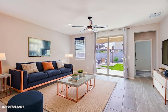 living room with light tile patterned flooring and ceiling fan