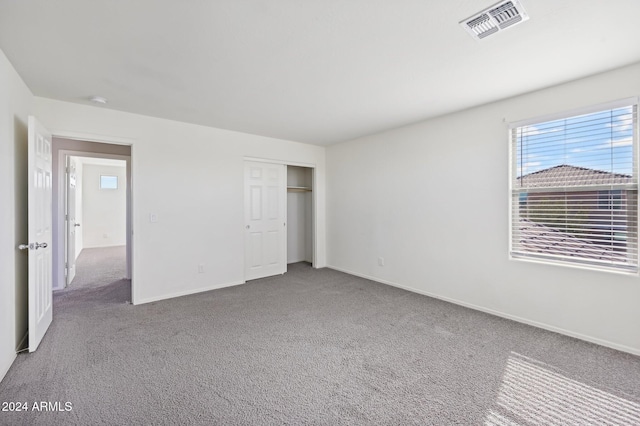 unfurnished bedroom with carpet and a closet