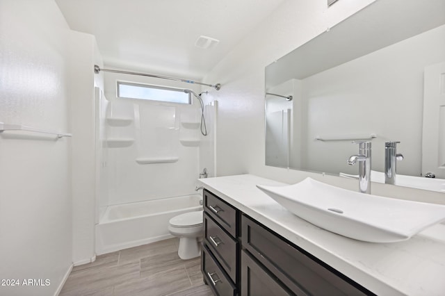 full bathroom featuring toilet, tub / shower combination, vanity, and hardwood / wood-style floors