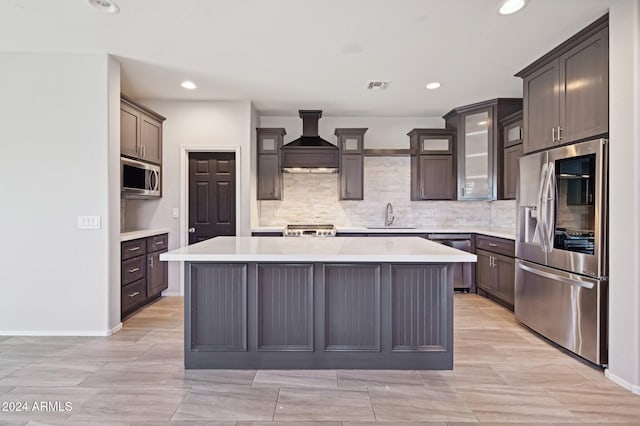 kitchen with sink, a center island, premium range hood, and stainless steel appliances