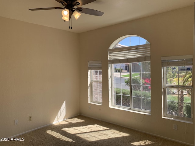 carpeted empty room with ceiling fan