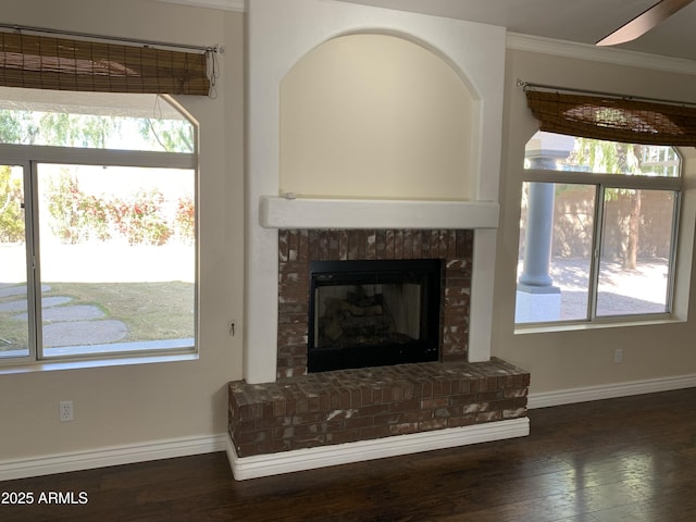 details with a brick fireplace, wood finished floors, and baseboards