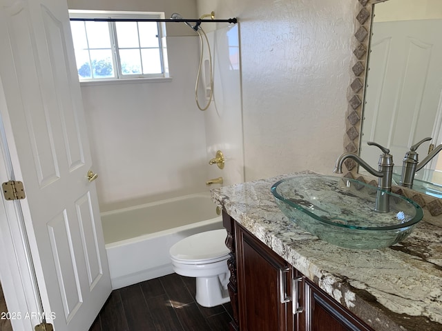 bathroom featuring shower / bathtub combination, wood finished floors, vanity, and toilet