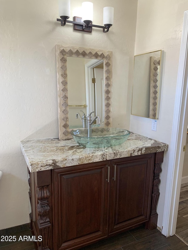 bathroom with vanity and wood finished floors