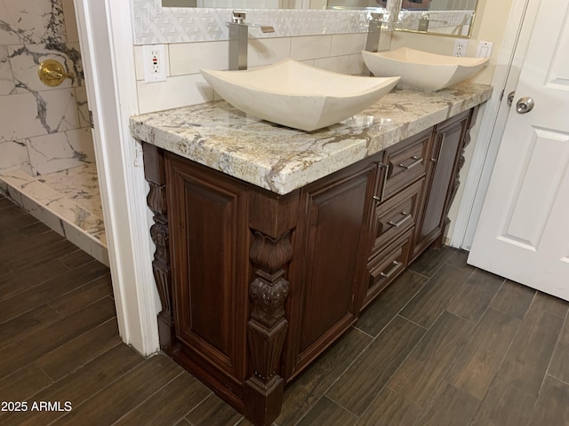 full bathroom with wood tiled floor, a sink, and double vanity