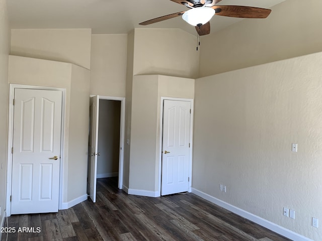 unfurnished bedroom with dark wood finished floors, a ceiling fan, and baseboards