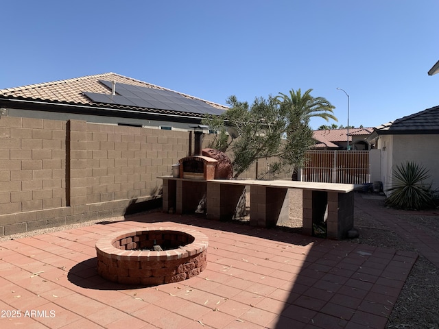 view of patio / terrace with an outdoor fire pit and a fenced backyard