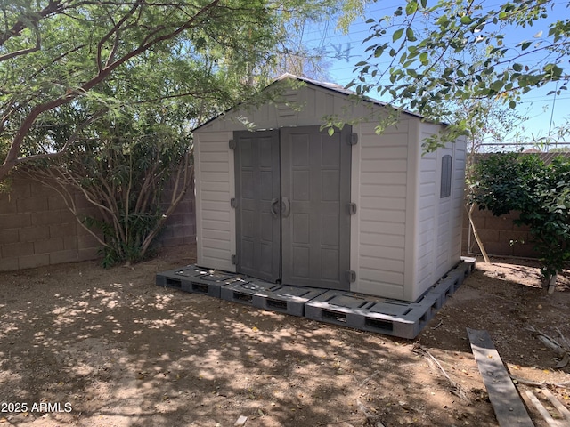 view of shed with a fenced backyard