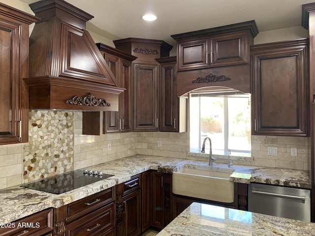 kitchen with light stone counters, black electric stovetop, stainless steel dishwasher, a sink, and premium range hood