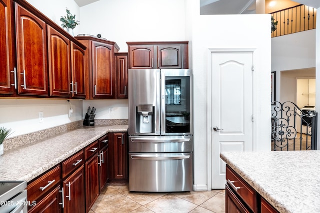 3511 W Allens Peak Dr, San Tan Valley, AZ 85144 - kitchen with stainless steel refrigerator with ice dispenser, light countertops, light tile patterned floors, and range