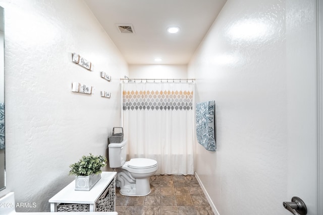 3511 W Allens Peak Dr, San Tan Valley, AZ 85144 - bathroom featuring toilet, stone finish floors, baseboards, and recessed lighting