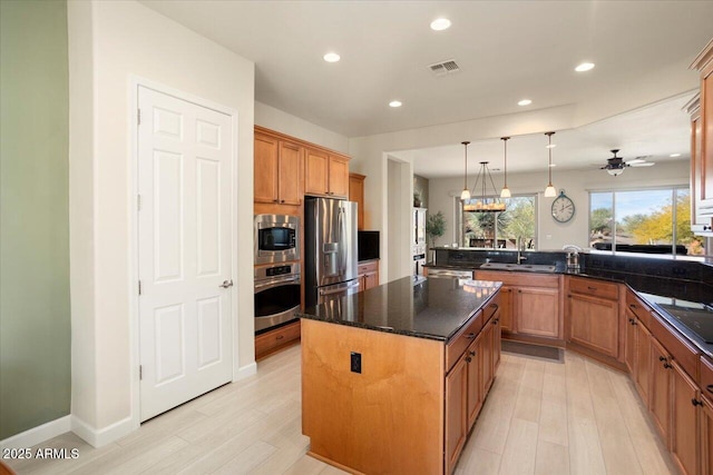 kitchen with a kitchen island, appliances with stainless steel finishes, sink, hanging light fixtures, and kitchen peninsula