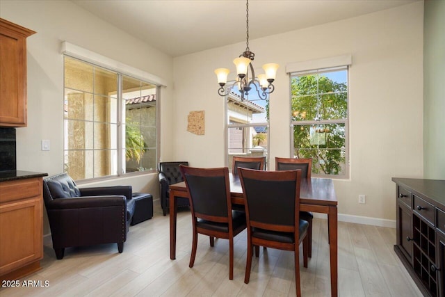 dining area featuring an inviting chandelier and light hardwood / wood-style flooring