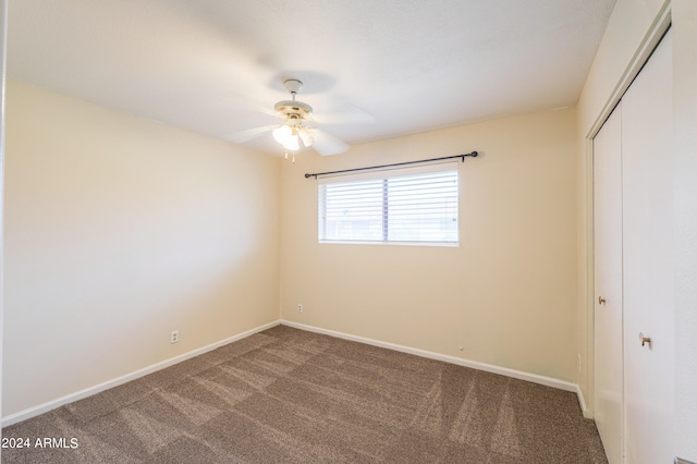 unfurnished bedroom with ceiling fan, a closet, and carpet floors