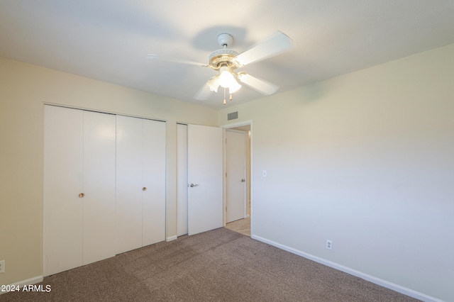 unfurnished bedroom with ceiling fan and light colored carpet