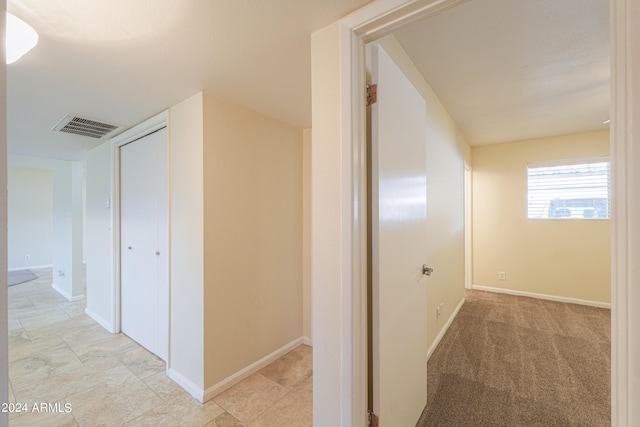 hallway featuring light tile patterned floors