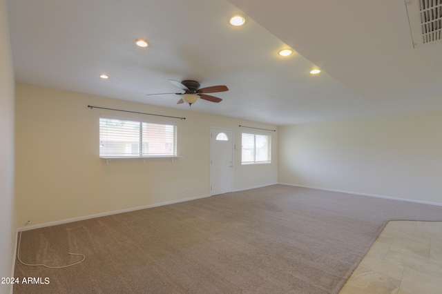 carpeted empty room featuring ceiling fan