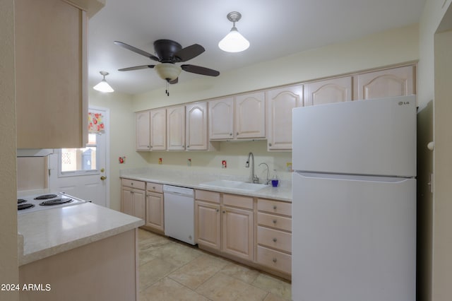 kitchen with light brown cabinets, pendant lighting, light tile patterned floors, white appliances, and sink