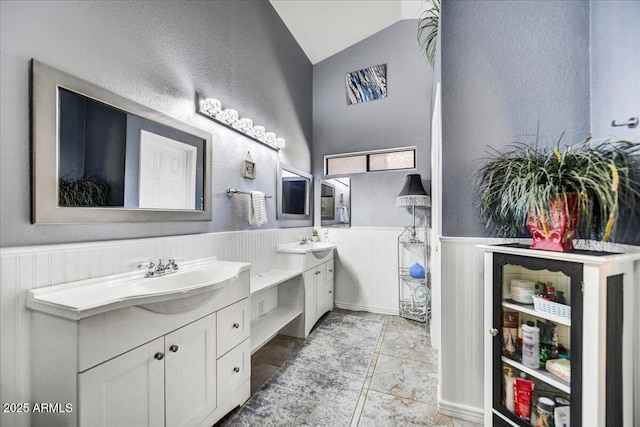 bathroom featuring lofted ceiling and vanity