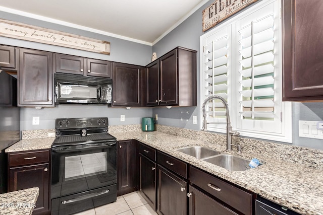 kitchen with light stone counters, dark brown cabinetry, a sink, ornamental molding, and black appliances