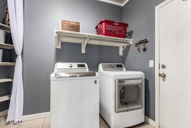 laundry area with laundry area, light tile patterned floors, baseboards, and separate washer and dryer