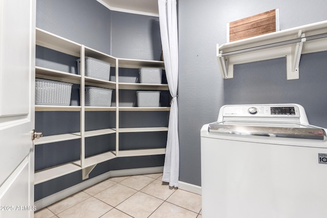 clothes washing area with tile patterned flooring, washer / clothes dryer, and laundry area