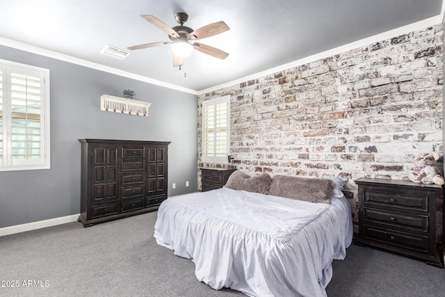 carpeted bedroom featuring ornamental molding, visible vents, and multiple windows