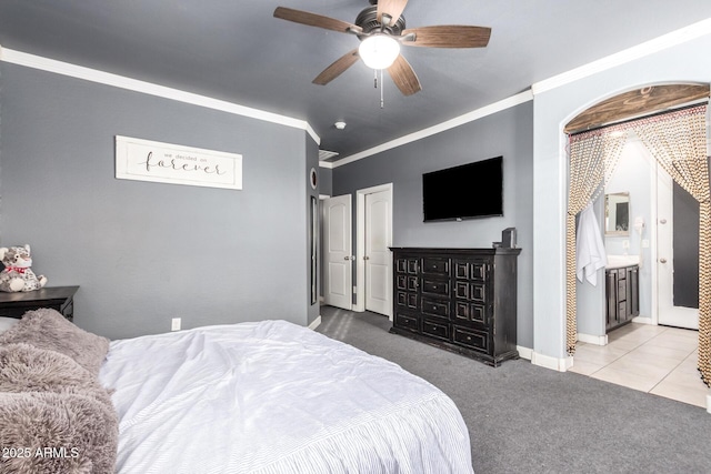 bedroom with a ceiling fan, carpet, ornamental molding, and baseboards