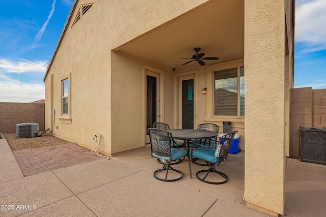 view of patio featuring central air condition unit, ceiling fan, fence, and outdoor dining space