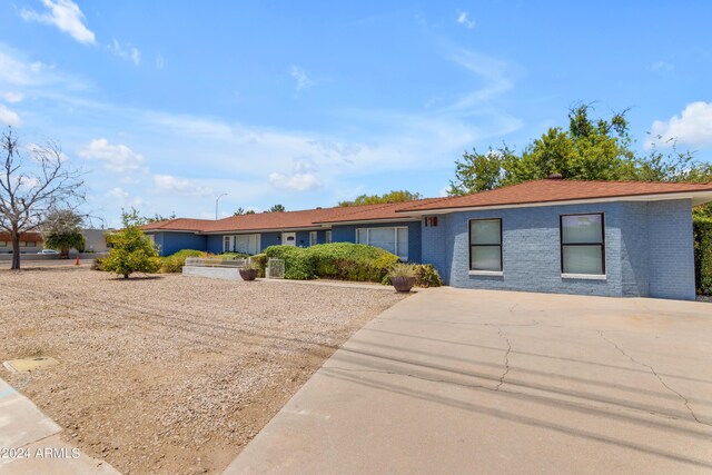 single story home featuring brick siding